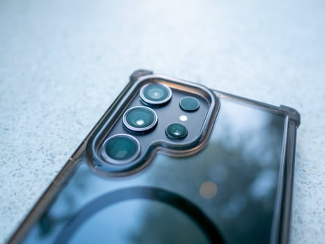 Mobile action close-up of smartphone camera indoor setting technology concept photo