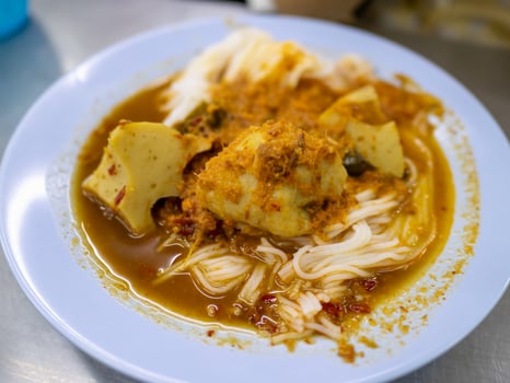Savoring urban curry noodles a close-up culinary experience at local eatery photo
