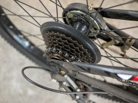 Bicycle gear mechanism close-up workshop industrial setting detailed view engineering concept photo