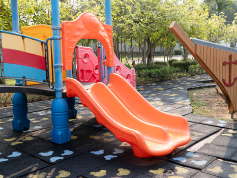 Children playing colorful playground slide park outdoor activity sunny day close-up view joyful fun photo