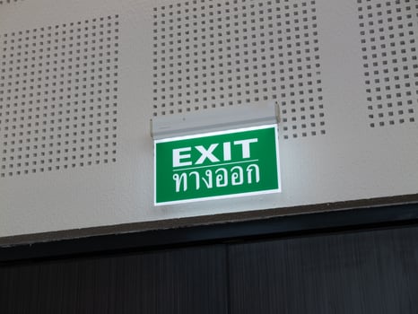 Emergency exit sign public building safety signage indoor straight view navigational guidance photo