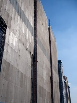 Construction workers scaling building facade urban cityscape high-rise environment safety focus photo