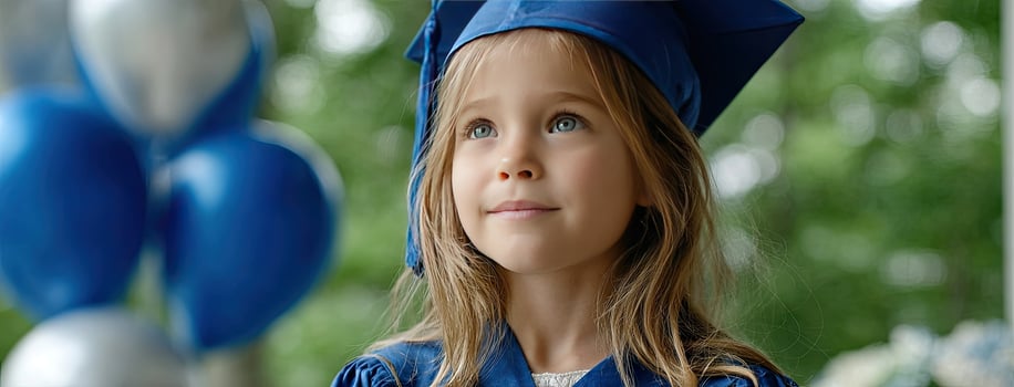 A young girl wearing a graduation cap and gown photo