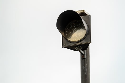 Daylight close-up of traffic light signal at urban intersection for vehicle safety alert photo