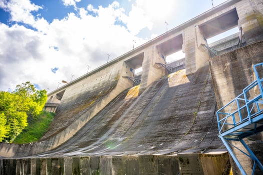 Orlik Dam and Hydroelectric Power Station in Czechia showcases its massive concrete structure under bright skies, harnessing river flow for energy generation in a scenic landscape. photo