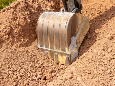 Heavy machinery and excavation equipment at construction site close-up industrial progress photo