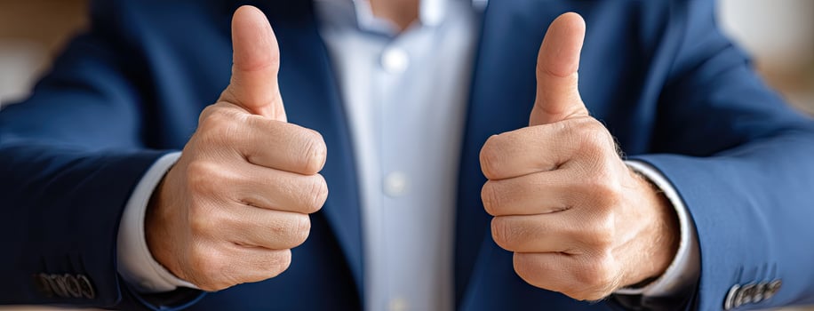 A man in a suit and tie is giving a thumbs up photo