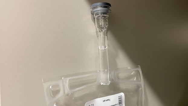 A plastic bag with a needle attached to it photo
