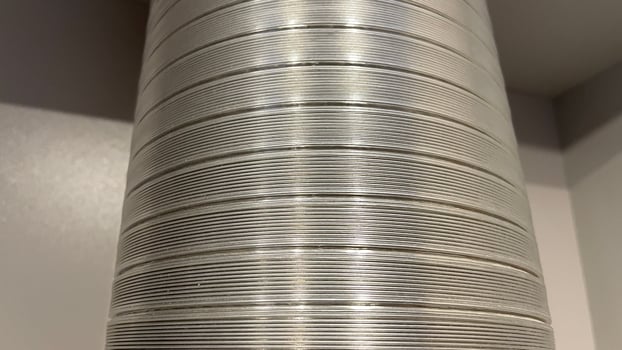 A close up of a metal tube with a white background photo