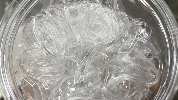 A clear plastic container filled with white plastic photo