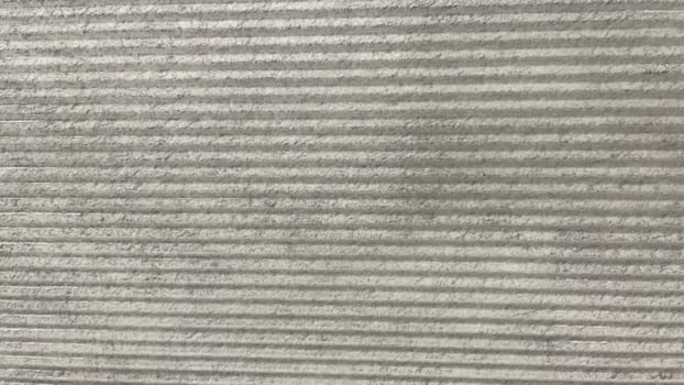 A close up of a concrete wall with a stripe pattern photo