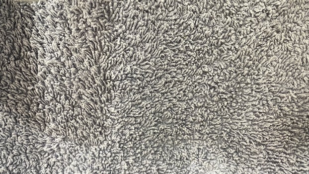 A close up of a gray rug with a white background photo