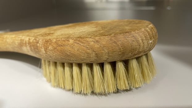 A wooden brush on a counter top photo