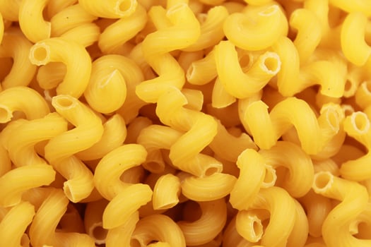 Close-up of dry uncooked cellentani pasta, top view. photo
