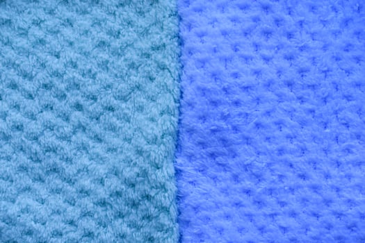 Beach towels on sunny sand. Background of colorful towels. Several soft terry towels. photo
