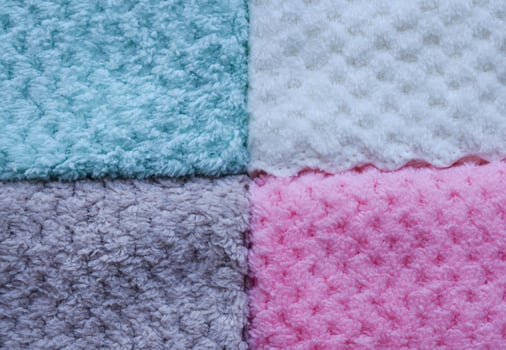 Boho-style striped towels close-up. Background of colorful towels. Several soft terry towels. photo