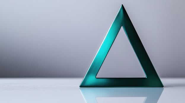 A green metal triangle on a table photo