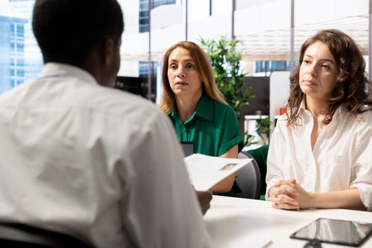Team of HR workers implementing diversity recruitment strategy for company, looking over resume. Teamworking colleagues reaching agreement with african american person during meeting photo