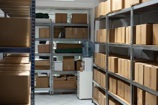 Spacious empty warehouse interior with shelving units and storage racks ready for goods, packages and cargo. Industrial facility supports shipping and mass production logistics. photo