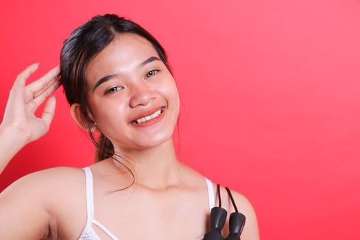 Woman asian beautiful with Jump Rope isolated red background photo