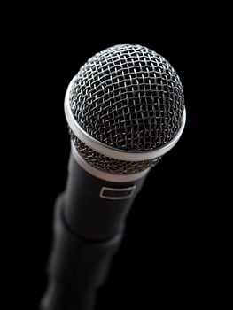 A black microphone on black background. photo