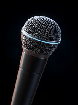 Black microphone on black background. photo