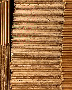 Rustic corrugated cardboard stacks, evoking Pachamamas earthy texture, prime for creative upcycling, or quirky Boxing Day projects photo