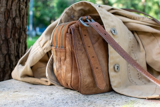 Brown Leather Wallet in Beige Canvas Bag with Outdoor Background photo