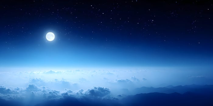 Full Moon Night Sky Above Mountains and Clouds photo