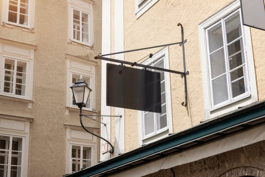Modern blank rectangular signage mounted on rods, ideal for contemporary store branding, urban business identity or advertising design mockups photo