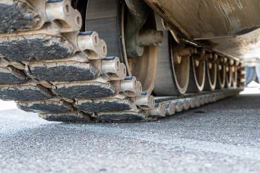Tank track close-up view from the bottom on asphalt photo