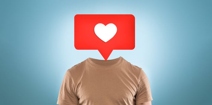A creative representation shows a person without a head, replaced by a red speech bubble featuring a heart icon. This artwork conveys themes of social media interaction and emotional expression. photo