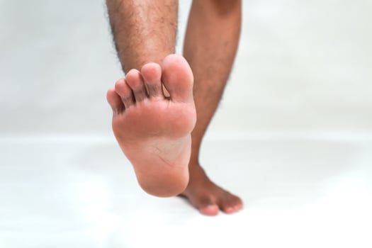 Close-up of the sole of a man's foot showcasing skin texture and foot anatomy, perfect for health and wellness visuals photo