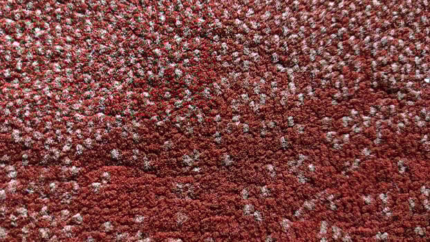 Intricate Red and Beige Textured Carpet Closeup - A Detailed Macro Shot Revealing the Woven Fibers and Pattern. photo