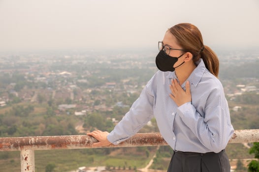 Businesswoman having respiratory allergy caused of by Bad air pollution PM2.5. photo
