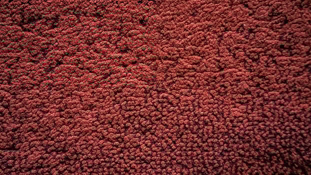 Closeup of Textured Burgundy Fabric Detailed Surface Abstract Background. photo