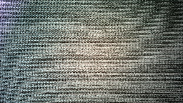 Detailed macro shot of a grey fabric, showcasing its complex weave and subtle variations in tone. The image emphasizes texture and pattern. photo