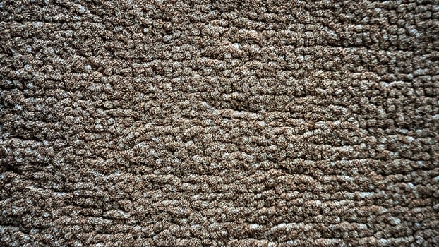A close up of a carpet with a brown color photo