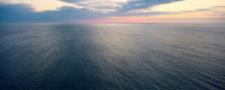 Expansive ocean surface at dawn. photo