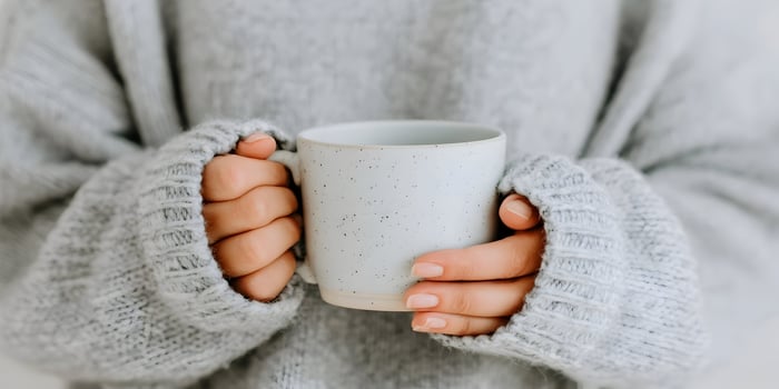 Woman Hands Holding Grey Speckled Mug Cozy Knit Sweater Winter Warmth photo