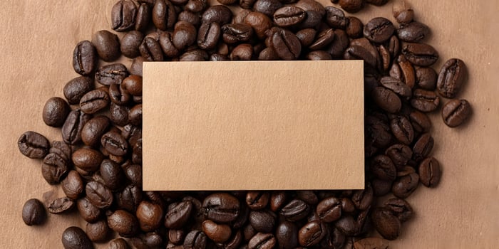 Brown Kraft Paper Blank Card Mockup Surrounded by Coffee Beans photo