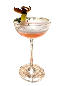 A cocktail with a garnish on top photo