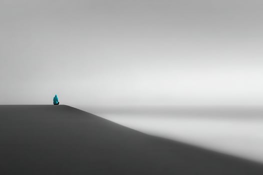 minimalist photograph of solitary figure on edge of coastal cliff in cyprus at sunrise photo