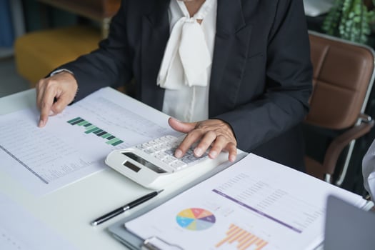 businesswoman using calculator to calculate the profit of a business photo