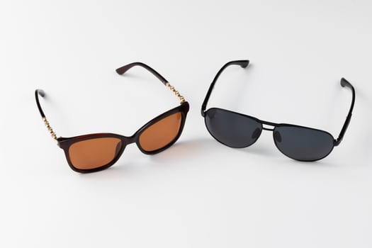 Sunglasses on a white background. Men's and women's sunglasses. Protection from the sun. Leisure and summer concept photo