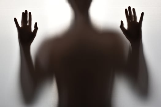 Body of a young man, Creepy shadow of a figure behind a curtain photo