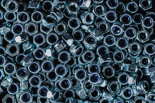 Fastening material. Metal nuts with anti-unscrewing check ring. Background image photo