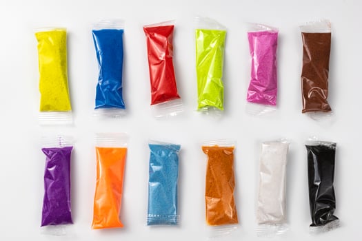 Set with colorful kinetic sand on white background photo