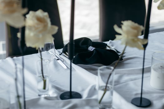 Close up table with flower decor and white tablecloth. photo