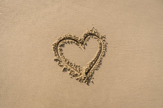 Heart on Textured Beach Sand Background photo